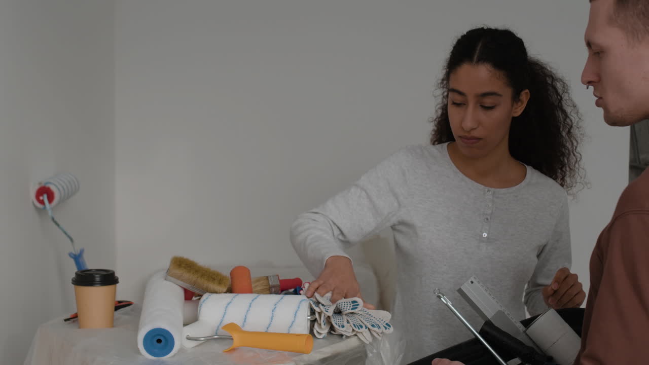 Young Couple Painting Their Home Together