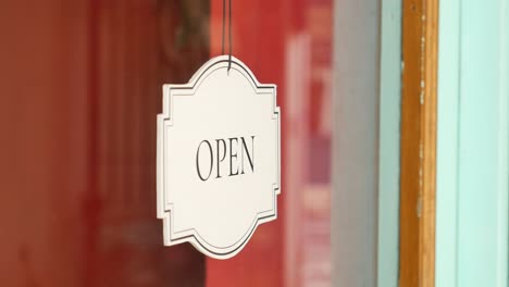 open sign hanging on a door