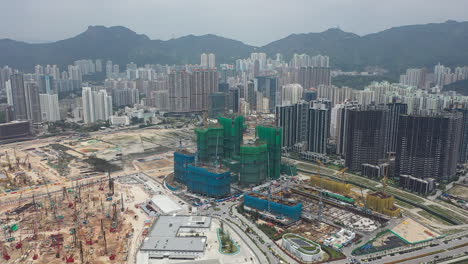 construction site surrounded by modern high-rise buildings in hong kong. aerial