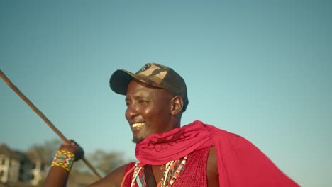 black african maasai warrior man holding a spear and preparing to hunt in kenya