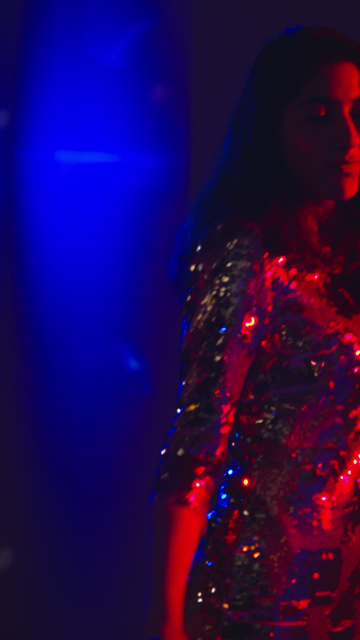 Vertical Video Of Woman In Nightclub Bar Or Disco Dancing With Sparkling Lights In Background 4