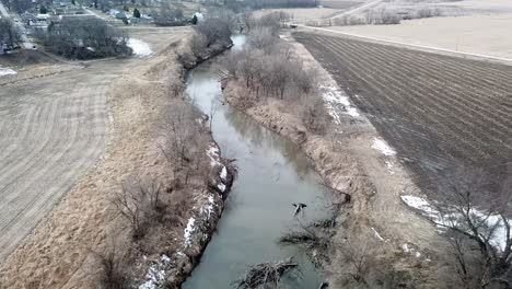 winter time aerial drone video of the skunk river and the rich agricultural farmland surrounding rural lynnville, iowa