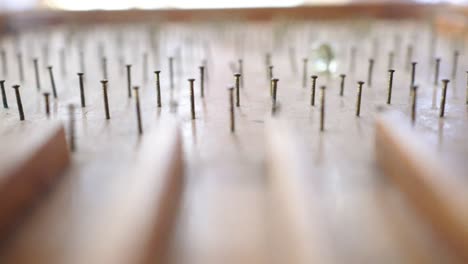 close up on pinball table made of wood. the glass beads roll down on the pinball table. a game played by a child.