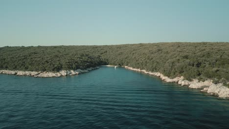 a serene bay with crystal clear water and lush green coastline on a sunny day