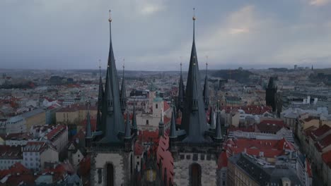 between the spires of prague's landmark church in the old town hall