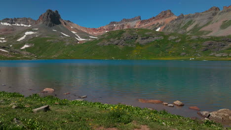 dreamy heavenly silverton ice lake basin aerial drone cinematic unreal deep sky blue stunning by island lake silverton colorado lush green summer incredible snow melting rocky mountains slider right