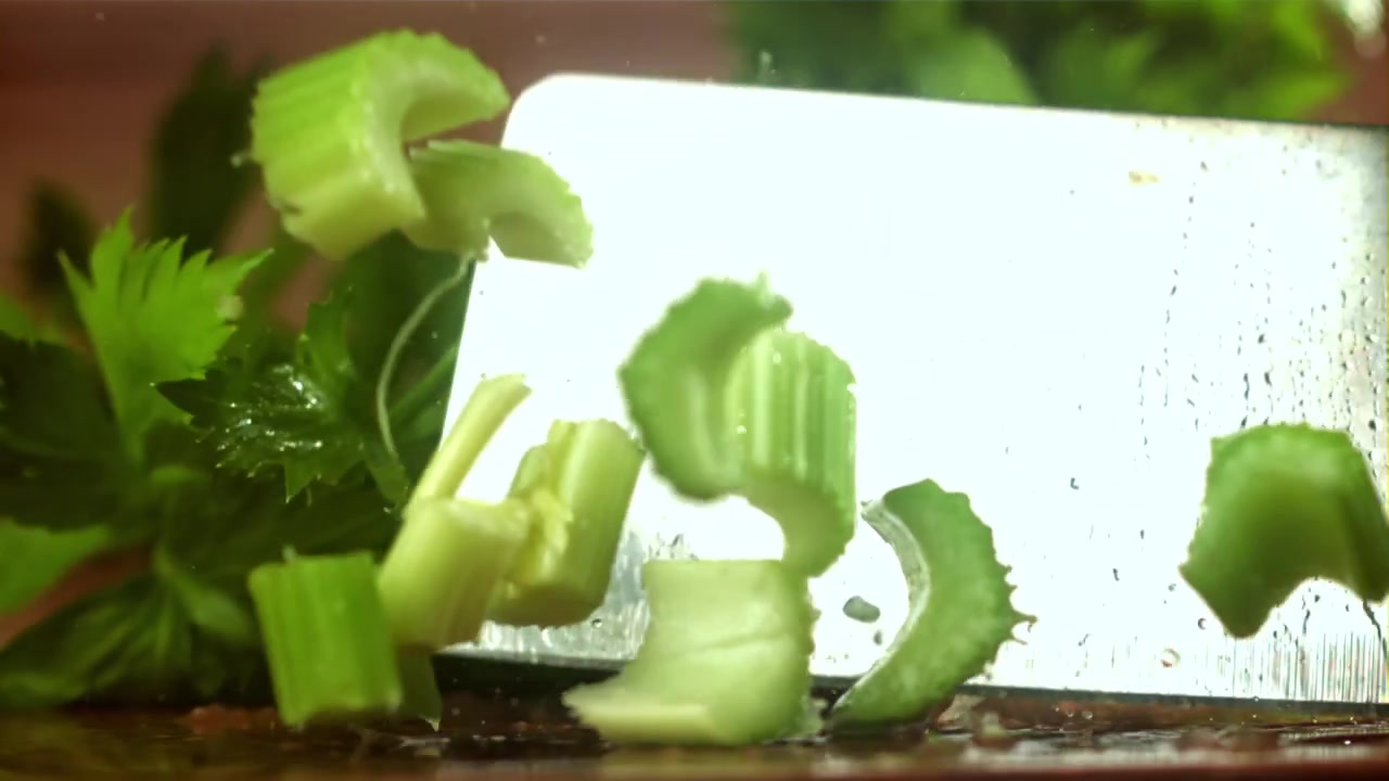 Fresh Celery Being Chopped in Slow Motion with a Knife