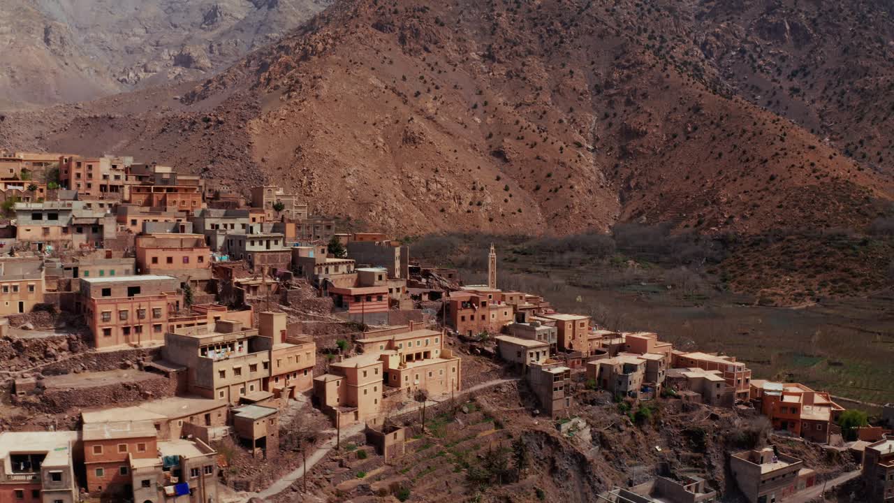 Aerial drone view of a remote rural Moroccan Village located on the High Atlas Mountains in Morocco.Camera flying around the village unveiling different prospectives.