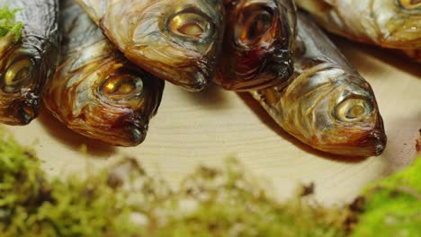 smoked fish on wooden board with moss