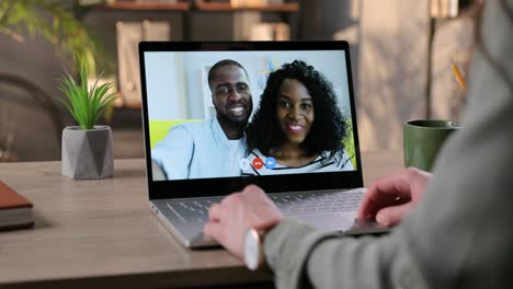 Girl-Sitting-In-Room-And-Video-Chatting-On-Laptop-With-Joyful-Couple-At-Home