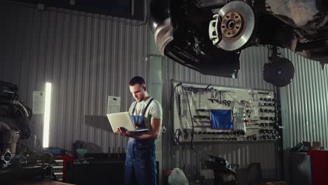mechanic using laptop in garage