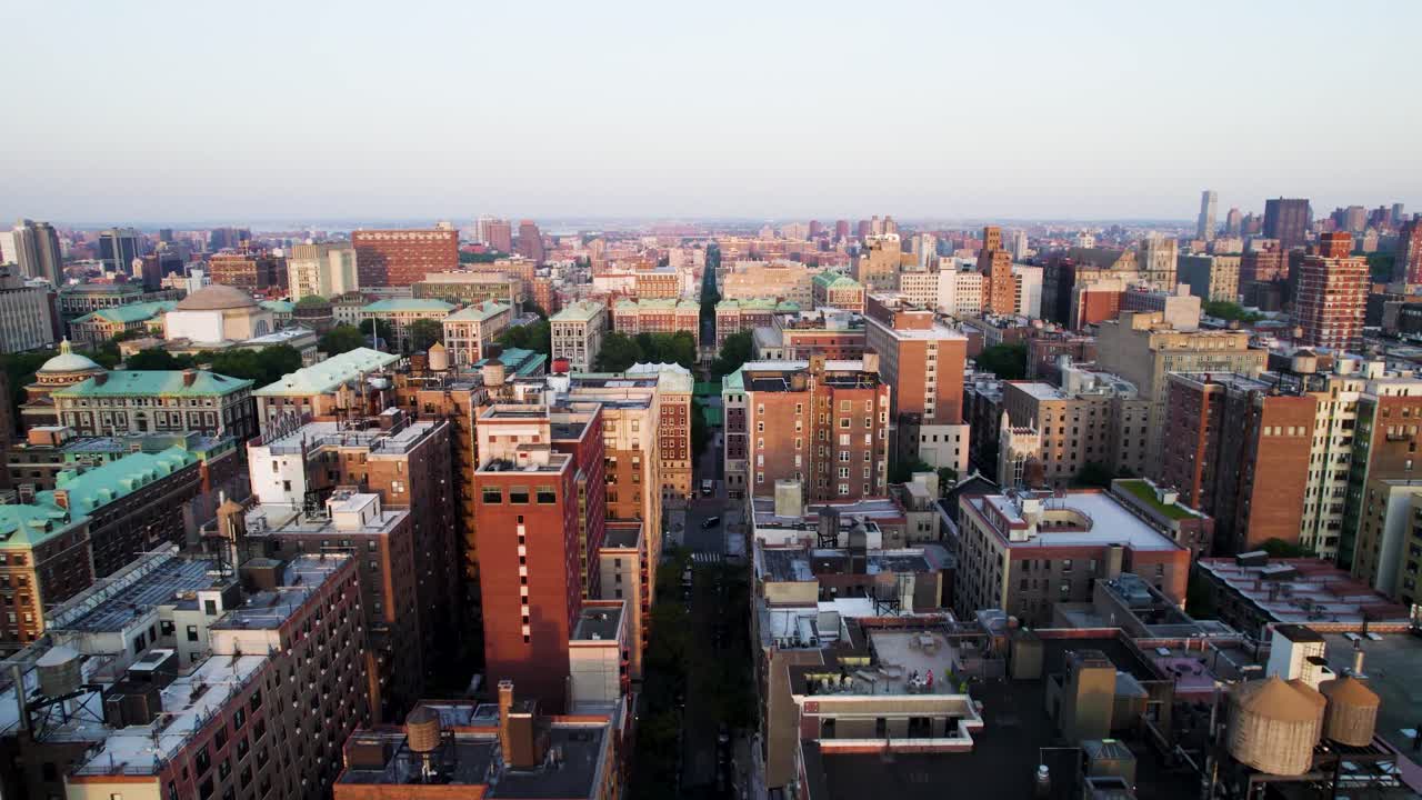 Long drone over Manhattan apartment blocks and Columbia University. NYC, Harlem and Upper West Side