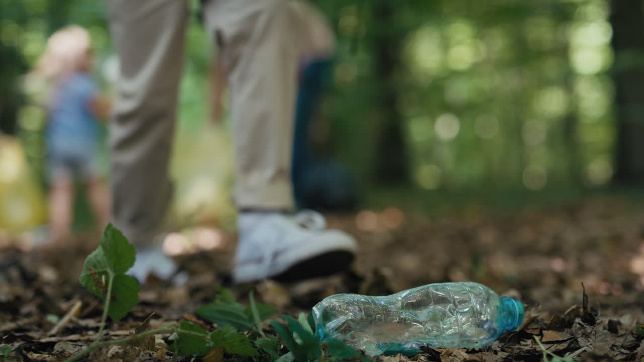 Close up of plastic bottle in forest which taken by boy with family.