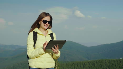 mujer joven disfrutando de un teléfono inteligente en un pintoresco telón de fondo de montañas cubiertas de bosque siempre