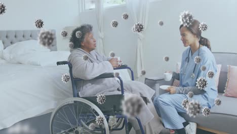 animation of covid 19 cells floating over nurse with female patient having tea in hospital