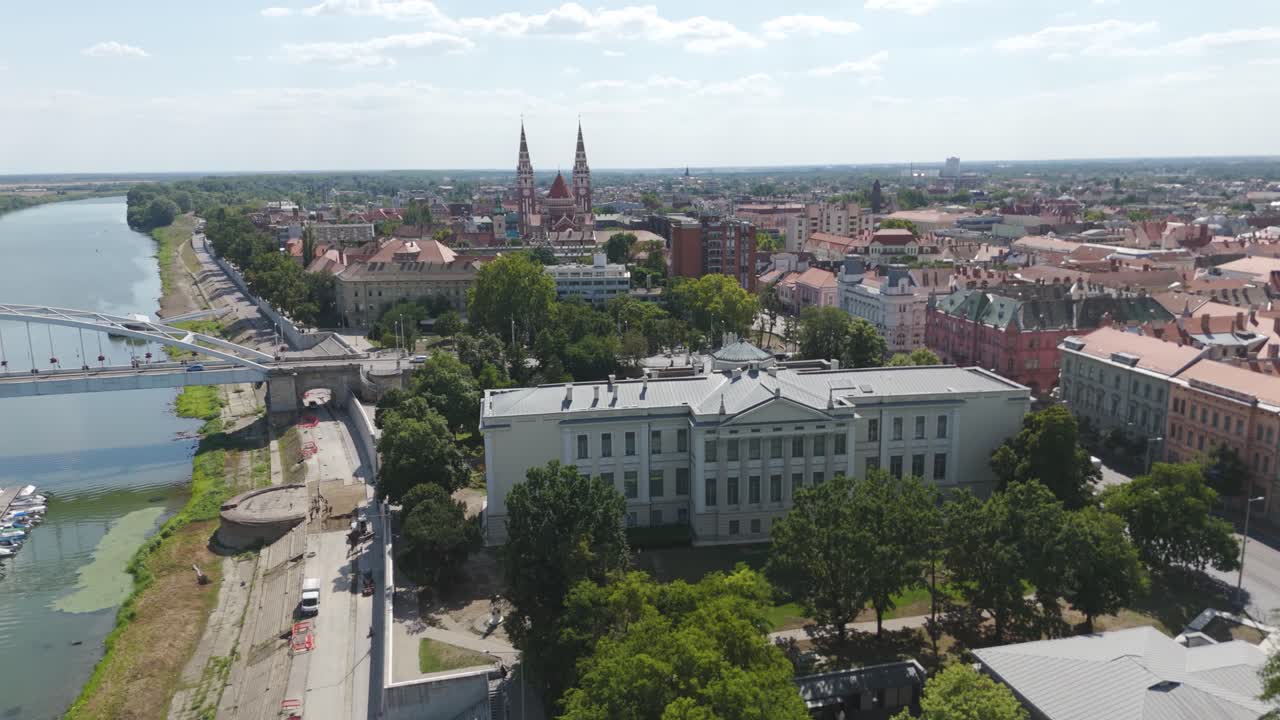 Aerial of Ferenc Móra Museum in Szeged, Hungary, with the Votive Church and Tisza River beautifully visible in the background