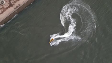jetskiing - aerial view of jet skier jet skiing in the lake