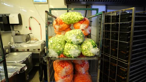 chopped vegetables stored in large plastic bags in commercial kitchen, meal ingredients