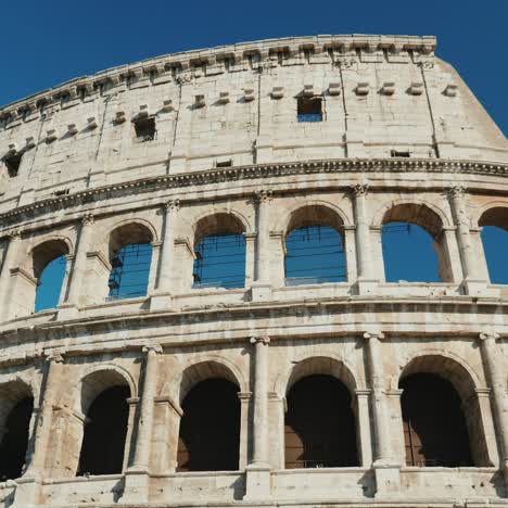 steadicam low angle shot: ancient coliseum in rome italy