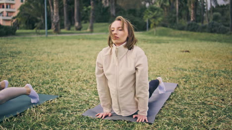 yoga woman training flexibility at nature. healthy girl performing asana at lawn
