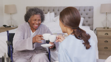 mixed race woman being visited at home by a nurse. social distancing and self isolation in quarantin