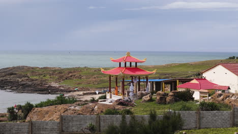 aerial of traditional whale worshiping temple with pagoda on the coastline of vietnamese ocean