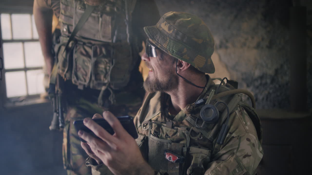 Soldiers Using Smartphones in a War Zone