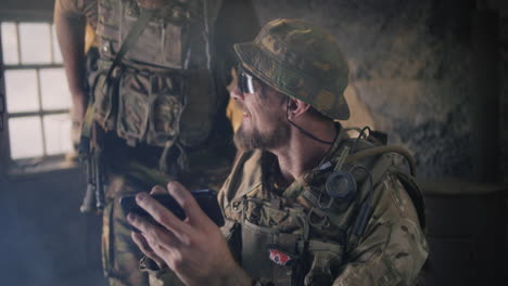 soldiers using smartphones in a war zone
