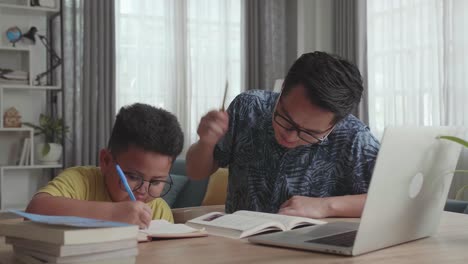 father helping son with homework