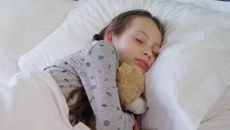 girl sleeping peacefully with teddy bear 4k