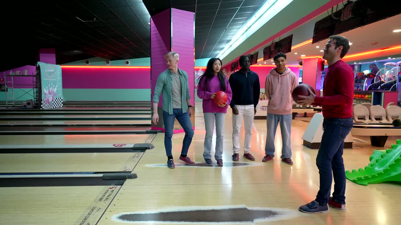 Group of people bowling indoors