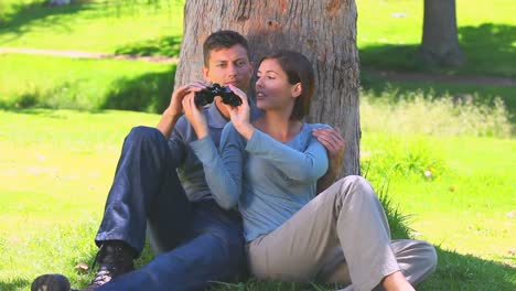 young couple watching something through binoculars