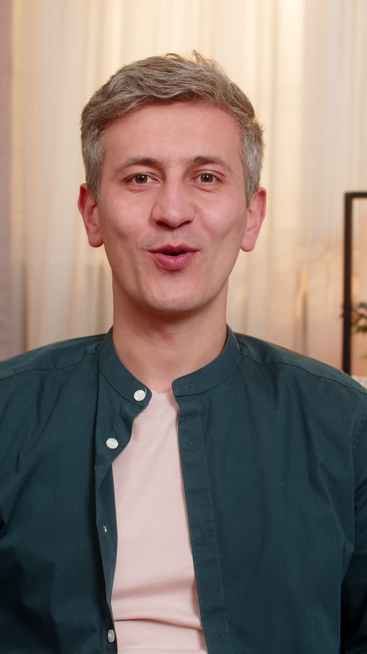 Man pointing at camera with excitement greeting hello friend during cheerful video conversation