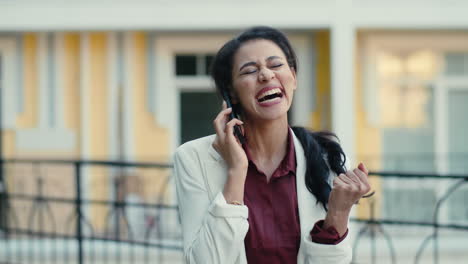 happy mixed race businesswoman talking cellphone outside. woman calling outdoors