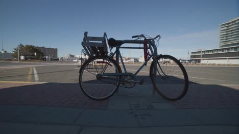 old bicycle parked on a city street
