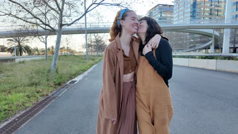two women embracing on an urban street