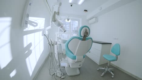 modern dental practice. dental chair and other accessories used by dentists in blue, medic light. fisheye