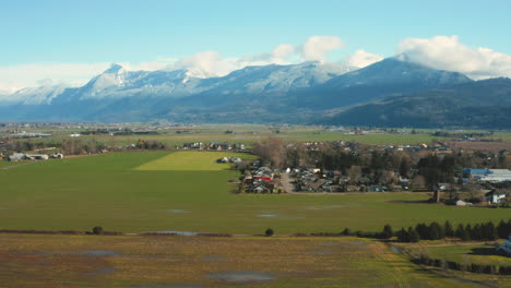 Aerial-rising-over-a-scenic-view-of-mountainside-farmland