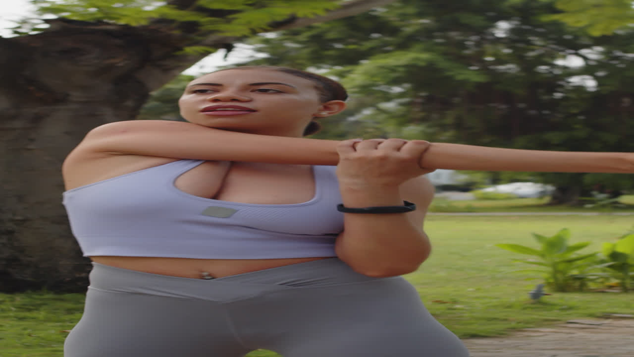 Vertical of Latin Sportswoman Warming Up in Park