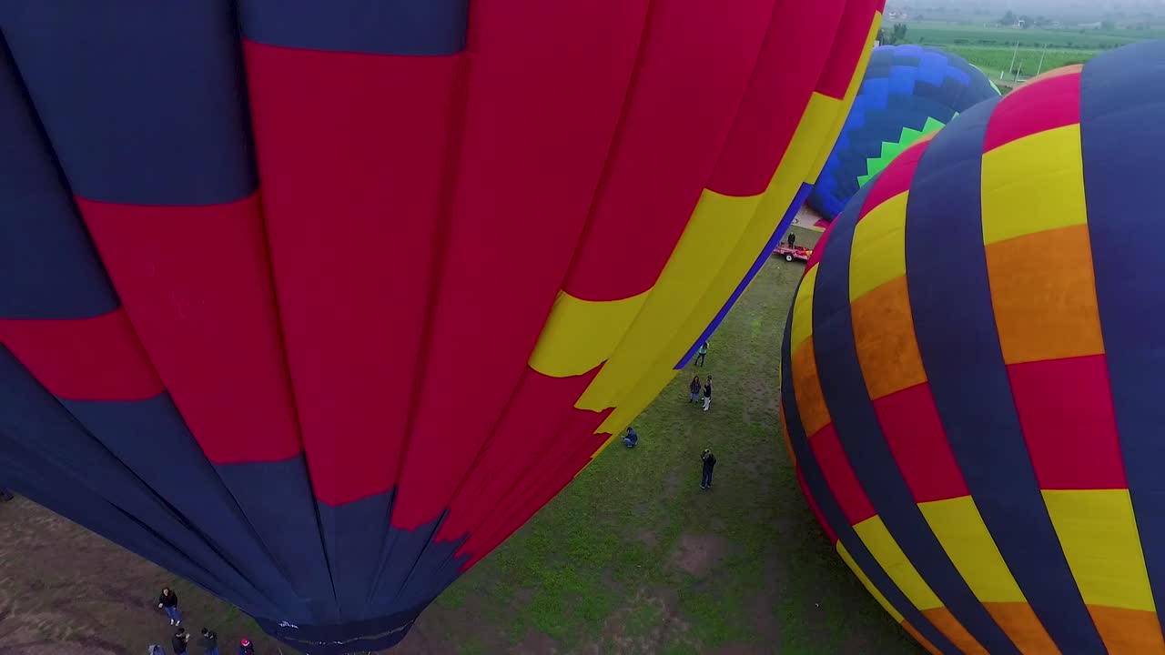People preparing hot air balloons before take off.