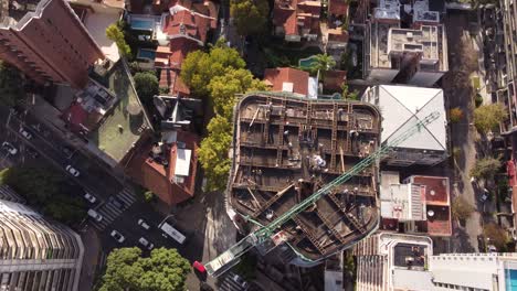 Rising-aerial-view-of-construction-site-on-high-rise-building