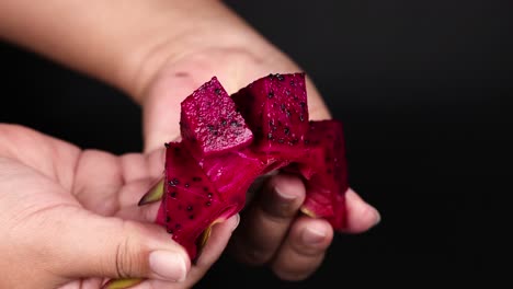 hands peeling and displaying sliced dragon fruit