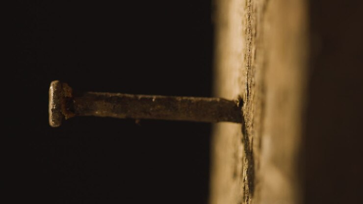 Religious Concept Shot With Close Up Of Old Rusty Nail In Wooden Cross