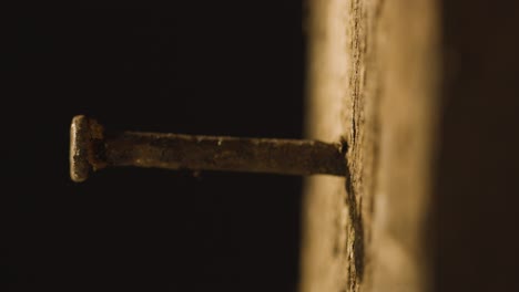 religious concept shot with close up of old rusty nail in wooden cross