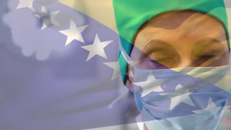 Animation-of-bosnia-and-herzegovina-flag-over-caucasian-female-surgeon-in-surgical-mask-at-hospital