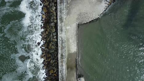 Topdown-footage-of-a-rocky-pier