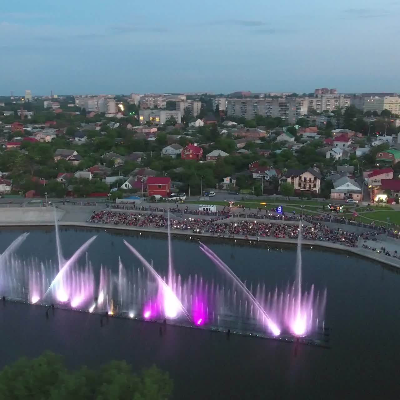Beautiful Dancing Fountain. Aerial shot of the colorful illuminated musical fountain at dusk