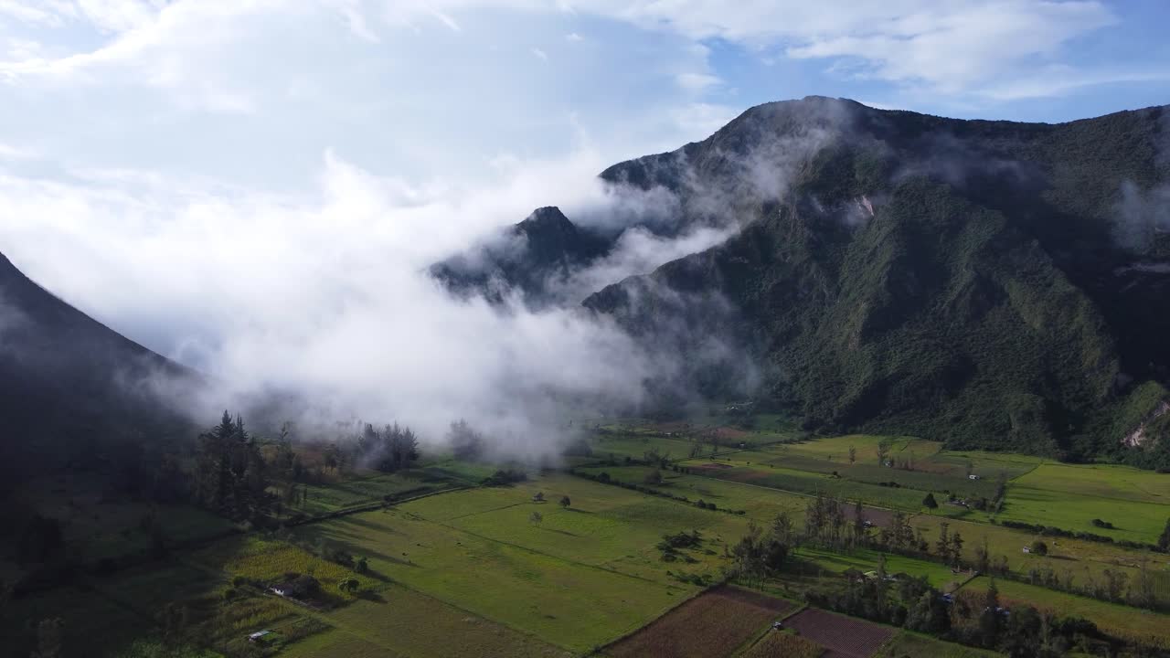 Aerial Drone Dolly-In of Fog Rolling Into a Volcanic Crater Farmland in Ecuador
