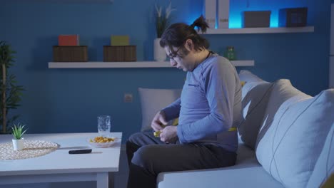 funny overweight man measuring waist thickness with tape measure.