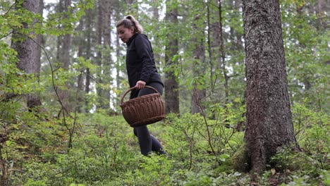 female hike on forest path holding basket for